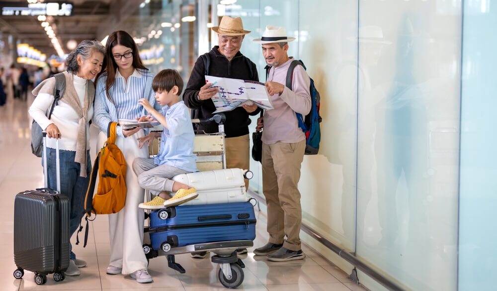 A family with luggage at the airport heading out for Thanksgiving travel.