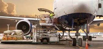 Loading cargo on the plane in airport, view through window