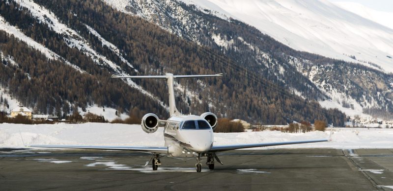 A private jet is ready to take off in the airport of St Moritz Switzerland in winter A private jet is ready to take off in the airport of St Moritz Switzerland in winter